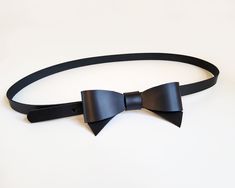 This beautiful and original belt is made of black firm natural leather. The leather bow on the front will perfectly accentuate your waist and highlight your personal style. The belt will look great on dresses and skirts. Belt closes with metal snap, which is hidden under leather bow- put belt tail through the loop and close it. The belt has three holes to adjust  your waist. ( In the video is a little bigger version of this belt) The size chart shows the waist circumference from the first hole t Chic Black Corset Belt For Formal Occasions, Chic Black Bow Tie For Formal Occasions, Chic Black Bow For Black Tie Events, Bow Belt, Leather Bow, Leather Bows, Waist Circumference, Suspender Belt, Black Colour