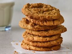 a stack of cookies next to a glass of milk