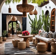 an outdoor living area with potted plants and furniture