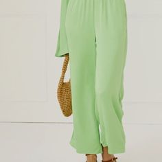 The Silky Wide Leg Pants In Green Are A Go-To For An Effortless Spring Or Summer Look. Available In A Wide Range Of Colors, This 100% Viscose Pull-On Pant Has A Wide Leg, Cropped Detailing, Side Pockets, And Elasticated Waistband. The Relaxed Silhouette Offers Comfortability, Yet Its Material Feels Sophisticated And Elevated. Wide-leg Jumpsuits And Rompers With Elastic Waistband For Loungewear, Green Solid Color Loungewear Pants, High-waisted Wide Leg Pants For Spring Loungewear, Wide Leg Solid Color Jumpsuits And Rompers For Loungewear, Solid High-waisted Spring Jumpsuits And Rompers, Spring Brunch Jumpsuits With Elastic Waistband, Summer Wide-leg Jumpsuits And Rompers In Solid Color, Green Wide-leg Jumpsuits And Rompers For Spring, Spring Wide-leg Pants In Solid Color