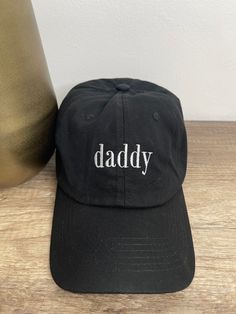 daddy dad hat, with white embroidered font. 100% cotton, adjustable fit. One size fits most. Casual Letter Print Hat For Father's Day, Cotton Dad Hat With Letter Print, Casual Father's Day Snapback Hat With Letter Print, Cotton Dad Hat With Letter Embroidery For Streetwear, Cotton Dad Hat With Letter Embroidery For Baseball Season, One Size Fits Most Dad Hat For Father's Day, Casual Snapback Dad Hat For Father's Day, Father's Day Cotton Snapback Baseball Cap, Casual Curved Bill Baseball Cap For Father's Day