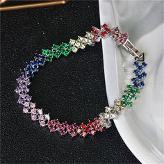 Update your jewelry box with this silvertone bracelet decorated with multicolor cubic zirconia. 0.31'' W x 7.08'' L Fold-over clasp Silvertone copper / cubic zirconia Cubic Zirconia Bracelet, Silver Plated Bracelet, Girly Accessories, Streetwear Fashion, Blue And Purple, Jewelry Box, Cubic Zirconia, Silver Tone, Statement Necklace