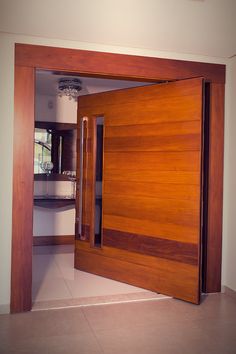 an open wooden door in the middle of a room