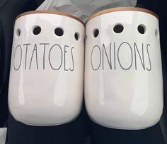 two white coffee mugs with holes in them that say potatoes and onions on them