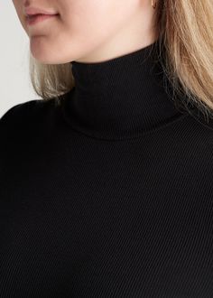 About Our Tall Long Sleeve Shirt Channel your inner Audrey Hepburn in our classic women’s tall turtleneck. This chic silhouette will never go out of style, and now you can wear one that fits your tall frame. The figure-flattering turtleneck rose to fame in the 1940s when it was worn by famous movie stars like Marilyn Monroe and has been a staple in fashionistas’ wardrobes ever since. We designed this tall long sleeve shirt as a timeless piece that can be dressed up or down for three-season wear. High Stretch Winter Mock Neck Top, Black High Neck Top With Ribbed Neckline, Classic Ribbed Turtleneck Top, Black Turtleneck Top With Ribbed Neckline, Fall Mock Neck Top With Ribbed Collar, Black Classic Funnel Neck Turtleneck, Classic Black Tops, Black Ribbed Turtleneck For Workwear, Black High Neck Turtleneck With Ribbed Collar