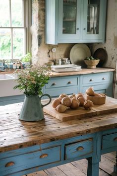 a wooden table topped with bowls filled with bread on top of it next to a window