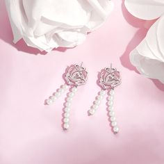 Be bold and dynamic, yet still retain a sense of delicacy and refinement, much like the combination of a flower petal and metal. Our "Rose Amour" Collection showcases an elegant rose design, reflecting the beauty and charm of love blossoming. At the center of each creation, a vibrant pink heart stone serves as a symbol of the passion, warmth, and devotion that are integral to every meaningful relationship. Immerse yourself in the dazzling world of the "Rose Amour" Collection and let its alluring Elegant Rose-colored Floral Jewelry, Elegant Rose Jewelry With Flower Charm, Feminine Silver Dangle Flower Earrings, Silver Dangle Flower Earrings Feminine, Elegant Dangle Pearl Earrings With Flower Charm, Silver Single Elegant Flower Earring, Rose Flower-shaped Elegant Earrings, Formal Rose Design Drop Earrings, Elegant Rose Flower-shaped Earrings