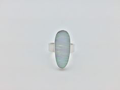 Hi everyone, just wanted to let you know we are open and shipping daily. White Fire Opal Ring Set in 925 Sterling Silver // Size 10 Length: 28 mm Weight: 7.2 grams Stone: lab created opal Origin: Japan Hallmark 925 This fire opal has been cultured in Japan over a three year period and contains the same chemical composition as natural opal. Modern Sterling Silver Opal Ring, Modern Sterling Silver Oval Opal Ring, Silver Opal Ring With Polished Finish, Modern Oval Opal Ring, Oval Opal Ring Stamped 925, White Opal Ring, Larimar Rings, Fire Opal Ring, We Are Open