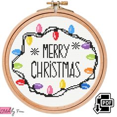 a cross stitch christmas ornament with the words merry christmas on it