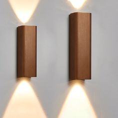 two wooden wall lights on a white wall