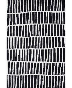 a black and white rug with vertical lines on the ground, in front of a white background