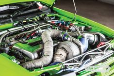 the engine compartment of a green sports car