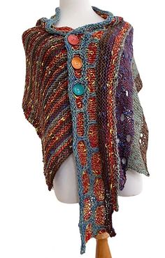 a mannequin wearing a multicolored knitted shawl with buttons on it