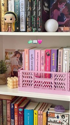 the bookshelf has many different colored books on it, including pink and yellow