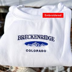 *SIZES ARE UNISEX* -I'd suggest your usual size for a more fitted look, or sizing up for a more relaxed fit. *these sweatshirts are extra comfy when oversized 🏔 "Breckenridge Colorado" with a mountain embroidered on a comfy vintage-style crewneck. Perfect for any occasion or gift for him or her. A sturdy and warm sweatshirt bound to keep you warm in the colder months. A pre-shrunk, classic fit sweater that's made with air-jet spun yarn for a soft feel and reduced pilling. Your new favorite swea Sporty Winter Tops With Embroidered Text, Sporty Winter Top With Embroidered Text, Sporty Cotton Sweatshirt For Hiking, Winter Sports Tops With Embroidered Graphics, Winter Sporty Sweatshirt With Embroidered Text, Winter Sports Top With Embroidered Graphics, Sporty Winter Sweatshirt With Embroidered Text, Sporty Sweatshirt With Embroidered Text For Winter, Sporty Crew Neck Sweatshirt For Hiking