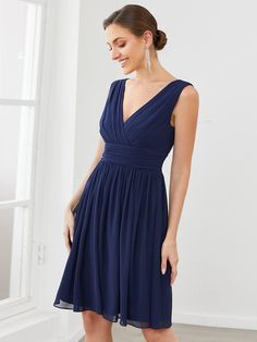 a woman in a blue dress is smiling