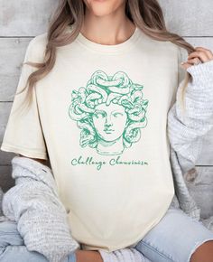 We love our comfortcolors tshirt featuring the Gorgon Queen, Medusa!  She rocks this along with the phrase "Challenge Chauvinism" and hope you will too!  Perfect for someone who wants to show their feminism or feministic spirit.  Let's reclaim Medusa's story and as a symbol of power & strength and use her image as a symbol of protection against evils! * Q U I C K * F A C T S * ✺ Pre-shrunk 100% US cotton for size retention using cotton that is ethically grown and harvested.  ✺ The relaxed fit ke Cute Greek God Shirts, Feminism Clothes, Light Academia Clothing, Selling T Shirts, Queen Medusa, Academia Clothing, Preppy Stuff, Clean Girl Aesthetic, Aesthetic T Shirts