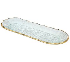 an oval glass dish with gold trimmings