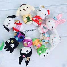 a group of crocheted stuffed animals sitting on top of a white wooden table