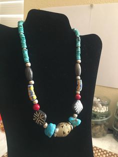 ** PLEASE READ EVERYTHING BEFORE YOU PURCHASE ** Hand made  pretty  NECKLACE with multiple vintage beads such as Kingman turquoise, African trade beads, agate beads, coral beads, silver beads, Asian wood beads, and other kind of turquoise beads. With an unique by my self I believe it is a nice gift for yourself or for your loved ones. . . . . . . . . . . . . . . . . . . . . . . . . . . . . . . . . . . . . . . . . . .. . . . . . . . . . . . .  -- size of the necklace: 19.4 inches long -- size of the  beads: the biggest one is the African Brass bead, 3 cm X 2 cm; -- size of the 2 big Kingman turquoise beads: 2 cm X 1.3 cm  -- size of the 2 wood beads: 2cm X 2 cm; -- weight of the necklace: 2.76 oz For getting the 50% discount,Please send me a message before order and I will change the price Handmade Bohemian Turquoise Necklace With Oval Beads, Artisan Turquoise Necklace With Large Multicolor Beads, Unique Beaded Turquoise Necklace For Beach, Multicolor Large Beads Turquoise Necklace For Festivals, Unique Multicolor Beaded Turquoise Necklace, Multicolor Turquoise Necklace With Large Beads For Festivals, Unique Multicolor Turquoise Necklace With Colorful Beads, Vintage Beaded Necklaces With Natural Turquoise Stones, Bohemian Turquoise Necklace With Colorful Round Beads