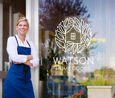 a woman standing in front of a glass door with her arms crossed and looking at the camera