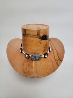 Beautiful wood-turned hat made from Ambrosia Maple signed and numbered by the artist, Brian Butler. Make a fashion statement in this unique hat! Measurements: Inside circumference: 22 inches Bill: 17.25" x 15" Height: 6.5" Weight: 3 lbs. ﻿Hatband and stand available for purchase separately. Artisan Top Hat For Country Events, Artisan Brown Top Hat For Kentucky Derby, Western Handmade Top Hat With Flat Brim, Unique Flat Brim Hat For Western-themed Events, Handmade Western Top Hat With Flat Brim, Unique Fedora With Curved Brim For Western-themed Events, Unique Fedora For Western-themed Events With Curved Brim, Artisan Top Hat For Kentucky Derby And Western-themed Events, Unique Curved Brim Hat For Country Events