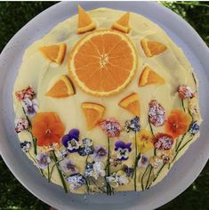 a cake decorated with orange slices and flowers