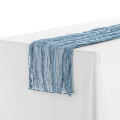 a white table topped with a blue scarf