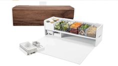 an open refrigerator with food in it next to a cutting board