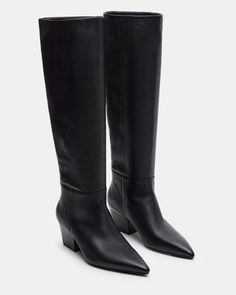 The EDEN boot features a pointed toe and knee-high design, providing a stylish and sophisticated look. These boots are durable and comfortable, making them a great addition to any wardrobe. Elevate your outfit with these elegant and versatile boots. 2.25 inch heel height Size 6 measurements: 15.25 inch shaft circumference, 16.5 inch shaft height Size 8 measurements: 16.5 inch shaft circumference, 17.25 inch shaft height Size 10 measurements: 17.75 inch shaft circumference, 18 inch shaft height L Elevate Your Outfit, The Eden, High Design, Pointed Toe Boots, Higher Design, Women's Boots, Eden, Knee High, Steve Madden