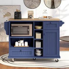 a blue kitchen island with an oven and microwave on it's stand in a living room