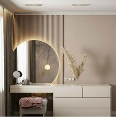 a white dresser sitting next to a mirror in a room with beige walls and flooring