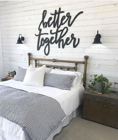 there is a bed with two lamps on either side and a sign above it that says, better together