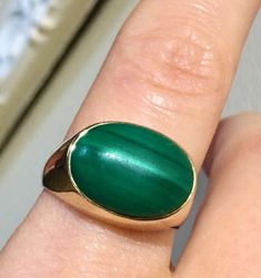 this Mans vintage ring is bezel set with natural Malachite large cabochon. set in yellow solid 14k gold. the ring is large and well built and the band is thick as well. So can be sized if needed. hallmark is 14k and tested.  the weight approx 7.14g the size 8USA  Cabochon approx - 15x11mm properties of malachite:  Malachite clears and activates the chakras and attunes to spiritual guidance. It opens the heart to unconditional love. Encourages risk-taking and change, breaks unwanted ties and outworn patterns, and teaches how to take responsibility for one's actions, thoughts and feelings. it's also known as the power stone. It has been said that malachite puts you on a path of success and prosperity. It can be worn by anyone. Malachite is also a birthstone for Capricorn. The malachite power Classic Green Oval Cabochon Signet Ring, Classic Green Cabochon Signet Ring, Classic Green Dome Ring In 14k Gold, Classic Green 14k Gold Dome Ring, Green Oval Signet Ring Collectible, Mans Ring, Power Stone, Vintage Navajo, Spiritual Guidance