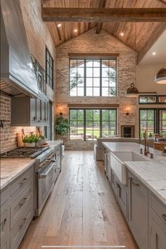 a large kitchen with wooden ceilings and white counter tops, along with stainless steel appliances