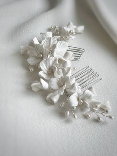 Floral bridal haircomb. Beautiful bridal hair comb, crafted with ivory clay flowers and decorated with freshwater pearls. Haircomb measures approx 17-18cm x 6cm. Available in silver, gold or rose gold colour wire. Order processing time has been extended due to high number of orders, so please DM if you need it posted sooner. As each of our pieces is handmade especially for you, we are unable to accept returns/exchanges Floral Hair Comb Wedding, Crystal Headpiece Wedding, Gold Bridal Hair Comb, Crystal Bridal Headpiece, Floral Hair Comb, Hair Piece Wedding, Beautiful Bridal Hair, Wedding Comb, Crystal Bridal Tiaras