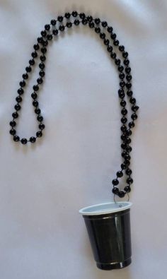 a black beaded necklace with a cup on it