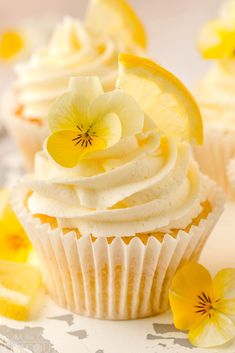 cupcakes with white frosting and yellow flowers