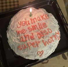 a birthday cake with the words you make me smile and also super hero written on it