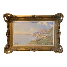 a painting hanging on the side of a wall next to a wooden frame with an ocean scene in it