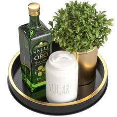 there is a bottle of liquid and a potted plant on the tray with it