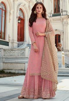 Faux Georgette Pakistani Suit in Pink This Semi-stitched attire with Poly Shantoon Lining is Enhanced with Resham, Zari and Stone Work and is Crafted in Round Neck and Quarter Sleeve Available with a Faux Georgette Palazzo in Pink and a Net Dupatta in Beige The Kameez and Bottom Lengths are 46 and 40 inches respectively Do note: Accessories shown in the image are for presentation purposes only and length may vary upto 2 inches.(Slight variation in actual color vs. image is possible). Latest Indian Outfits, Pakistani Sharara Suit, Pakistani Sharara, Sharara Dress, Designer Sharara Suits, Ramadan Collection, Gharara Suits, Palazzo Suit, Dress For Wedding