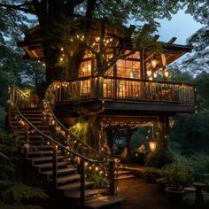 a tree house is lit up with fairy lights