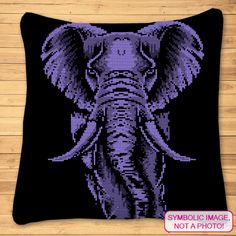 an elephant cross stitched on a black pillow with the words symbolic image, not a photo