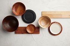 wooden bowls and plates are arranged on a shelf