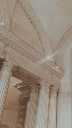 the interior of a building with columns and arches