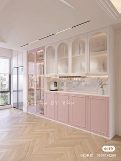 an empty kitchen with pink cabinets and wood flooring on the walls, in front of a large window