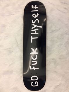 a black skateboard with white writing on it