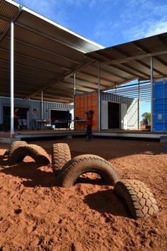 two large tires laying on the ground in front of a building