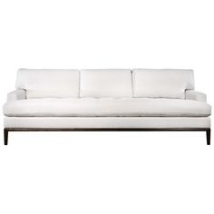 a white couch sitting on top of a wooden frame